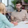 Professional team practicing communication and listening skills in a meeting – explain active listening skills in workplace